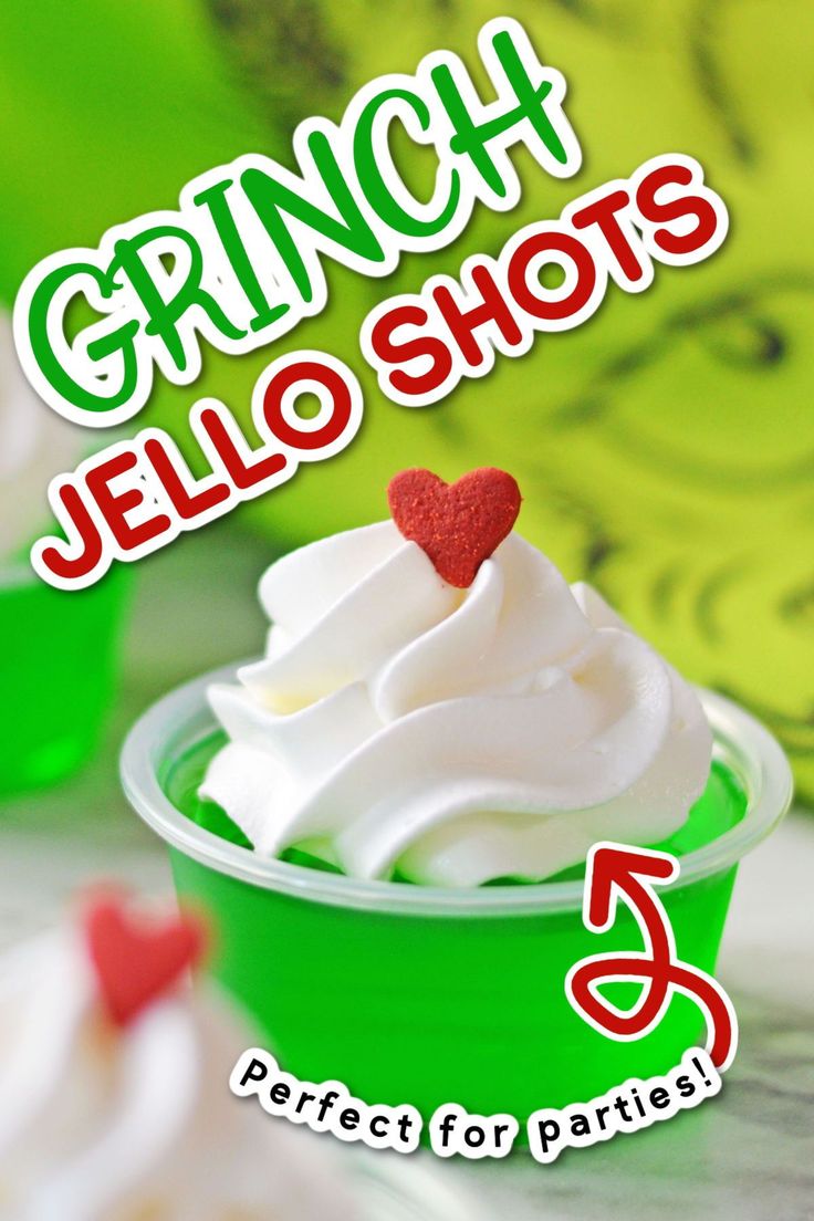 a green cup filled with whipped cream and topped with a red heart on the top