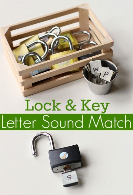 a wooden box filled with keys next to a metal lock and key holder on top of a white table