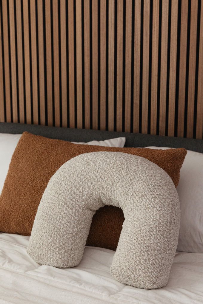 Add a playful touch to your favorite accent chair with this arch shaped boucle pillow. Crafted with comfort and style in mind, its fun shape makes it the perfect cuddle companion. Boucle fabric Modern arch shape Indoor use only Cushion Styling Couch, Cushion Styling, Calming Bedroom Colors, Apartment Planning, Boucle Pillow, Ny Apartment, Tv Area, Curved Furniture, Decor Objects