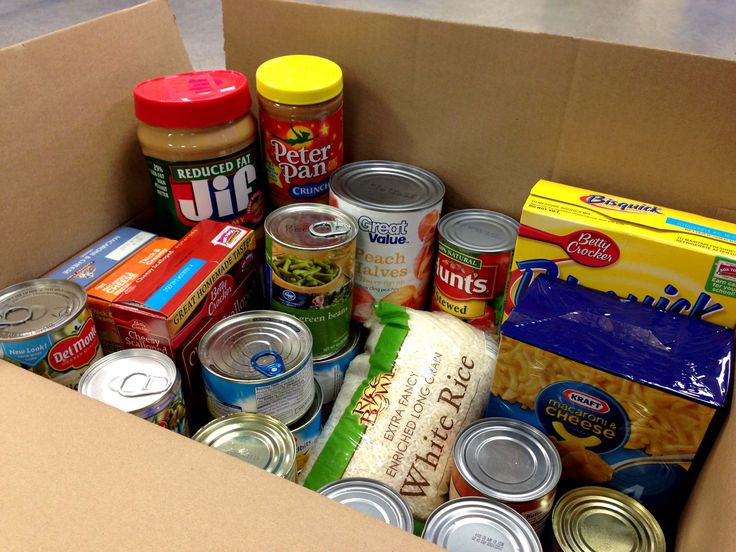 an open cardboard box filled with food and condiments