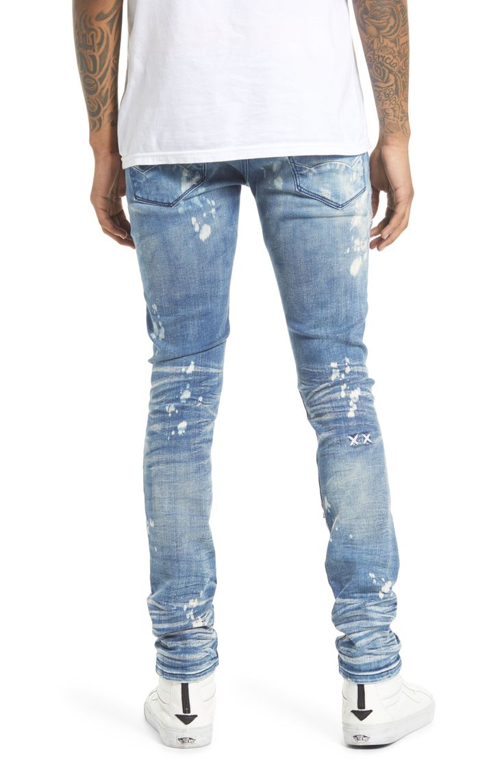 These super-skinny stretch-denim jeans are given a punk-rock update with a bleached wash covered in rips and paint splatters. A branded utility belt adds to the grunge aesthetic. 32" inseam; 11 1/2" leg opening; 10 1/2" front rise Zip fly with button closure Five-pocket style Removable utility belt 86% cotton, 10% spandex, 4% polyester Machine wash, line dry Imported Men's Clothing Distressed Slim Fit Cotton Jeans, Distressed Slim Fit Jeans, Slim Fit Distressed Cotton Jeans, Edgy Slim Fit Jeans For Streetwear, Fitted Punk Jeans For Streetwear, Punk Style Fitted Jeans For Streetwear, Fitted Punk Style Jeans For Streetwear, Punk Style Distressed Blue Jeans, Blue Distressed Punk Jeans