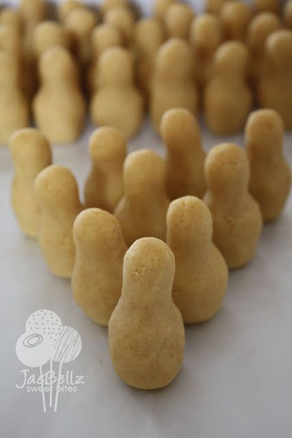 small wooden figures are lined up on the counter top, with one standing out from the crowd