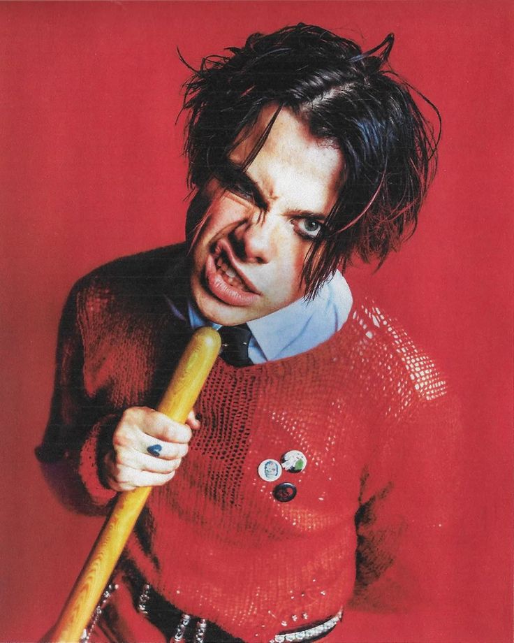 a man in a red sweater holding a baseball bat