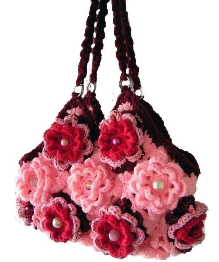 a crocheted purse with pink flowers on it