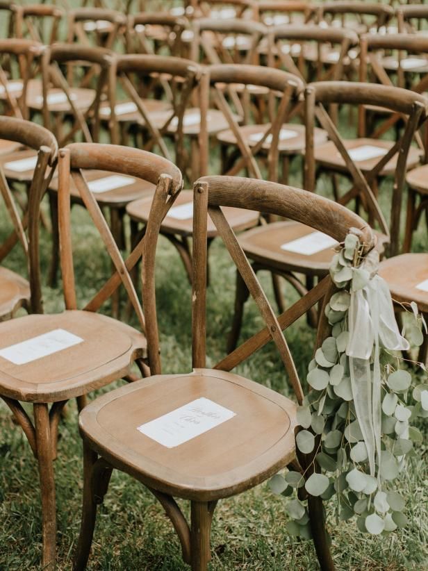 rows of wooden chairs with white tags on them