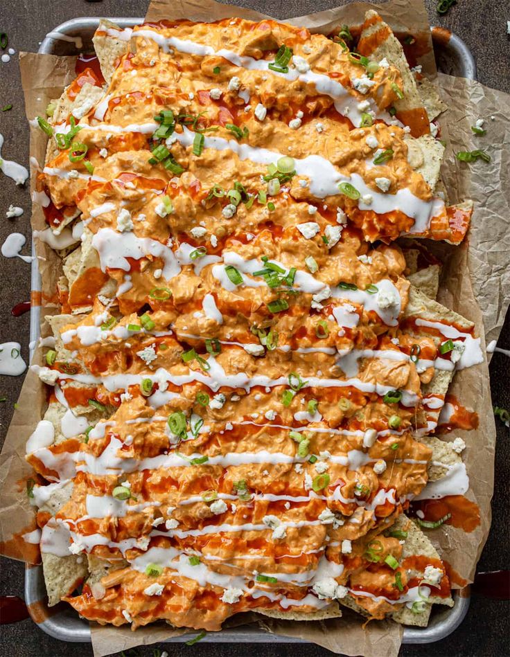 an overhead view of mexican chicken nachos with sour cream sauce