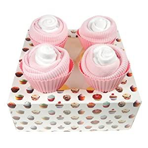 three pink cupcakes with white frosting in a box on a white background