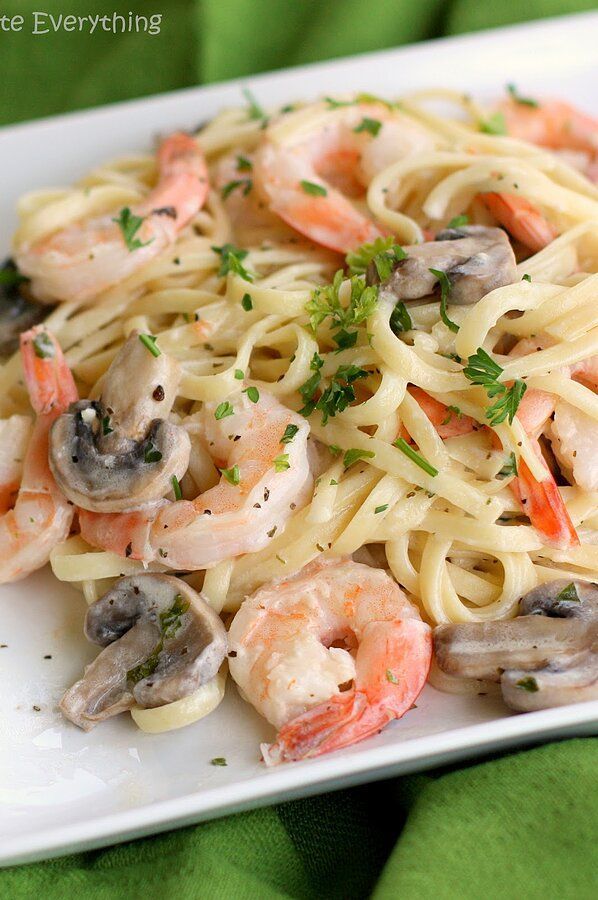 pasta with shrimp and mushrooms on a white plate