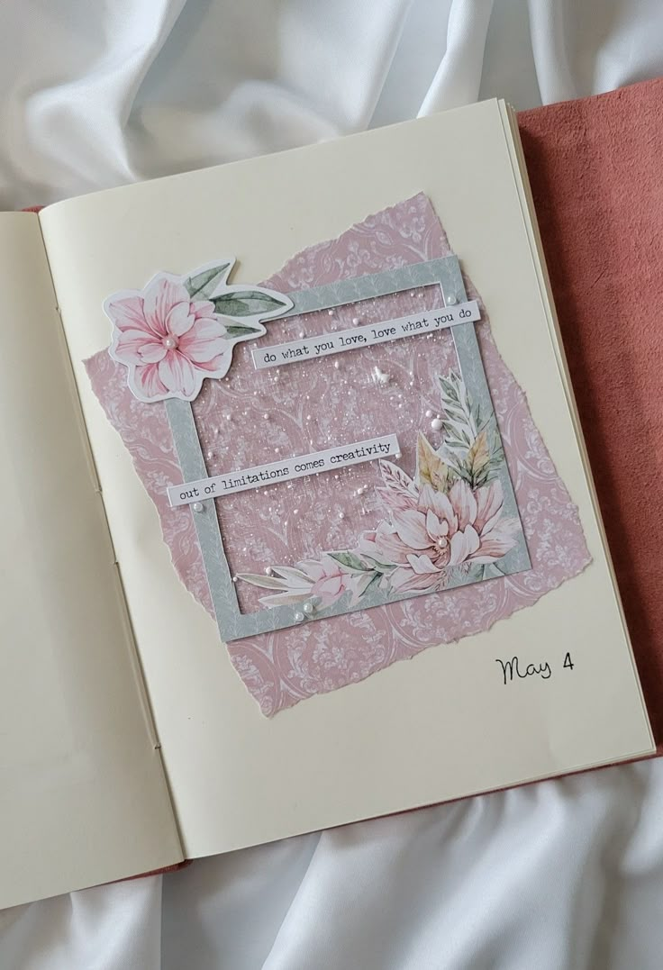 an open book with paper flowers on it