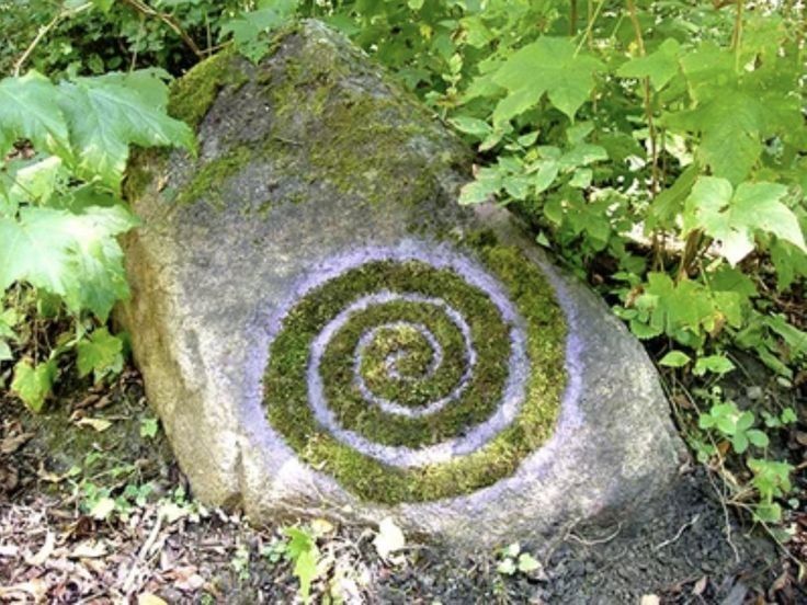 a rock with a spiral painted on it