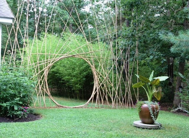 a garden area with a circular sculpture in the middle