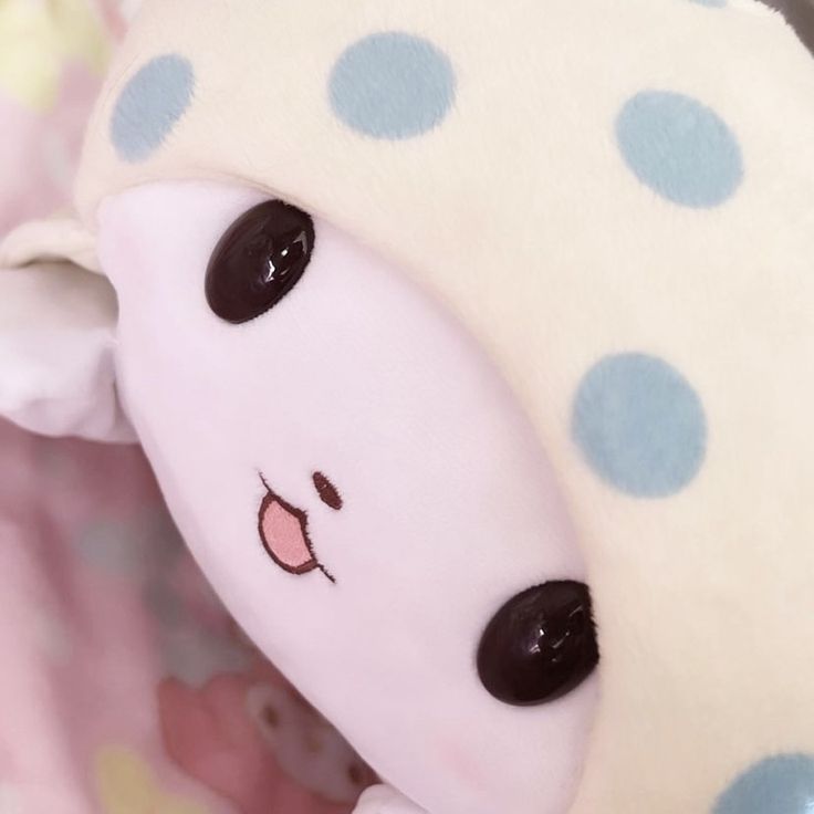 a close up of a stuffed animal with polka dots