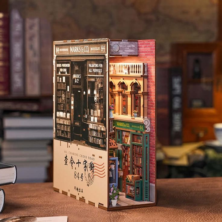 an open book sitting on top of a wooden table next to bookshelves and shelves