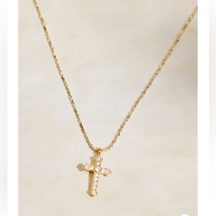 This Timeless Necklace Features A Shimmering Cubic Zirconia Cross Pendant Crafted In 18k Gold Plating. The Classic Design Adds A Touch Of Elegance And Faith To Any Ensemble. Fit: Adjustable Closure: Clasp Material: 18k Gold Elegant Cubic Zirconia Cross Necklace With Clavicle Chain, Classic Cubic Zirconia Cross Necklace As Gift, Classic Cubic Zirconia Cross Necklace For Gift, Gold Diamond Cross Pendant Necklace For Wedding, Gold Diamond Cut Cross Necklace As Gift, Gold Pendant Cross Necklace Fine Jewelry, Gold Necklace With Diamond Accents In Dainty Style, Gold Cross Necklace With Diamond Accents For Anniversary, Dainty Gold Necklace With Diamond Accents