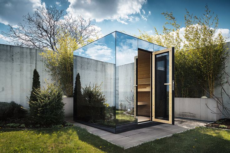 an outdoor sauna in the middle of a garden