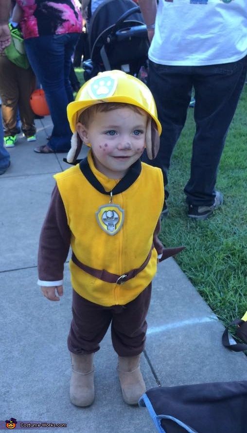 a little boy dressed up as a fireman