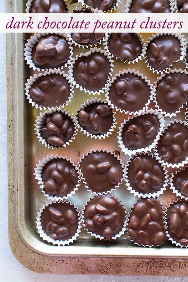 chocolate peanut clusters in a baking pan with the words dark chocolate peanut clusters