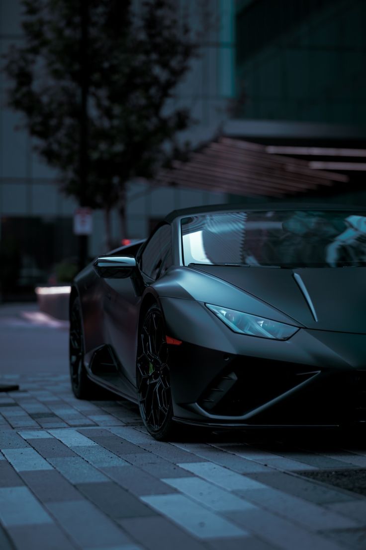 a dark colored sports car parked on the street