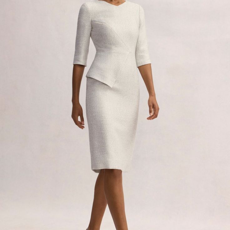 The Winter White Shade Is Eternally Versatile, While The Italian Tweed Has A Subtle Shimmer Finish That Catches The Light Beautifully. Overall, It's Tailored To A Clean, Elegant Silhouette, With Elbow-Length Sleeves And A Striking Asymmetric Peplum Detail. Wear With A Sleek Yet Comfortable Heel And Let The Compliments Roll In. 47% Cotton, 35% Polyester, 12% Acrylic, 6% Viscose Lining: 62% Acetate, 38% Polyester Dry Clean Beautiful Dress New, Never Worn, Still Has Tags White H-line Spring Dress, Tailored White Long Sleeve Dress, White Tailored Long Sleeve Dress, Tailored White Dress For Formal Occasions, Tailored White Dresses For Formal Occasions, Elegant Tailored H-line Dresses, Classic White Midi Cocktail Dress, White Formal Midi Dress With Fitted Bodice, White Fitted Bodice Midi Dress For Formal Occasions