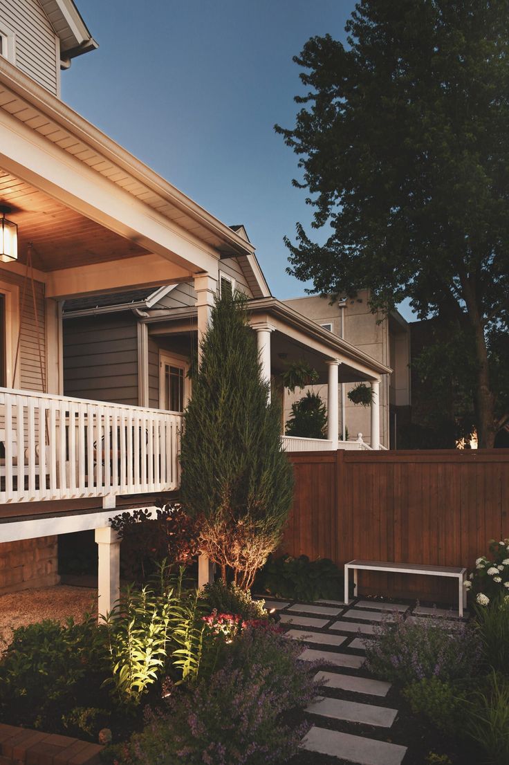 a white bench sitting in front of a house