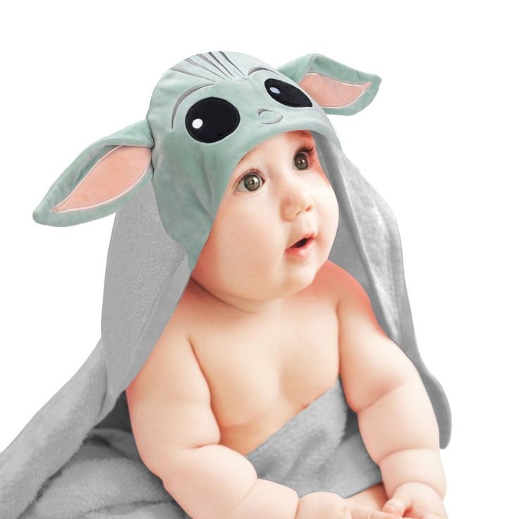 Your little padawan will love being wrapped in this soft and cozy Star Wars Mandalorian Baby Yoda hooded towel. The hood is velour and is lined in cotton terrycloth. The pure cotton terry towel is absorbent, and the binding is a dyed to match cotton jersey. Celadon green velour was used for the Child’s face along with embroidered silver-gray satin stitches. The gray hooded towel is 34” wide X 23” high and is rmended for babies up to 30 pounds. This makes an amazing baby shower gift or welcome ho Baby Hooded Bath Towel, Lambs & Ivy, Welcome Home Baby, Star Wars Mandalorian, Baby Bath Towel, Stylish Nursery, Hooded Bath Towels, Baby Dino, Dinosaur Plush