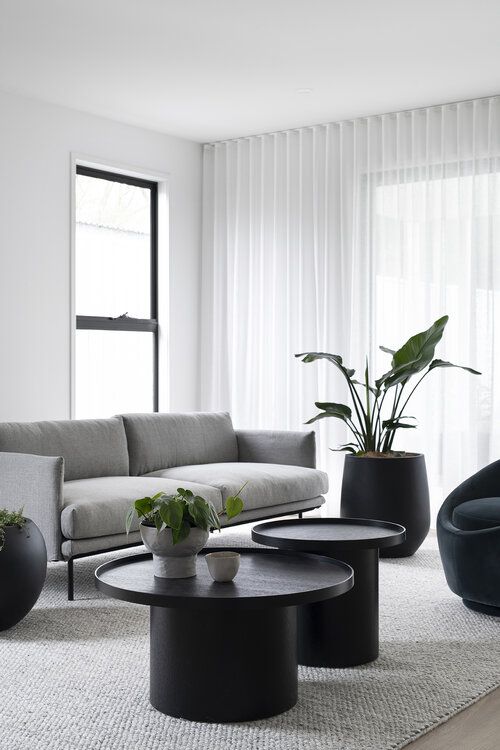 a living room filled with black and white furniture