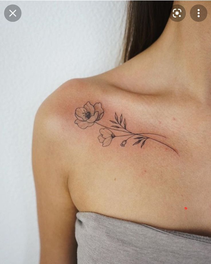 a woman with a flower tattoo on her shoulder