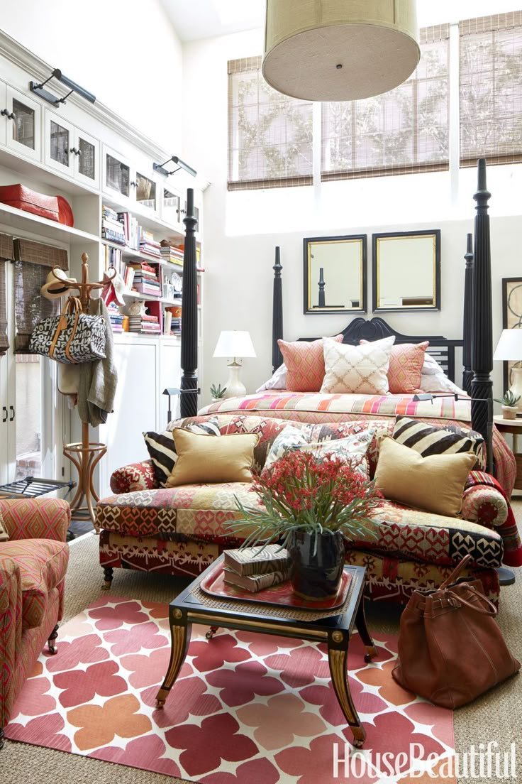 a living room filled with lots of furniture and decor on top of a carpeted floor