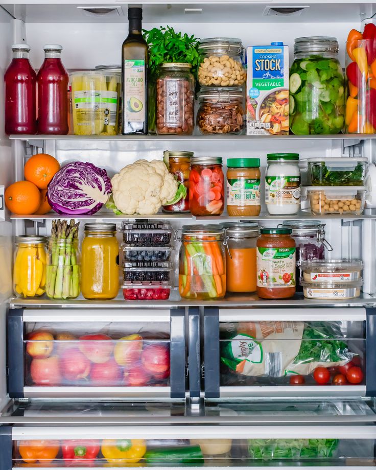 an open refrigerator filled with lots of different types of vegetables and fruit in it's doors