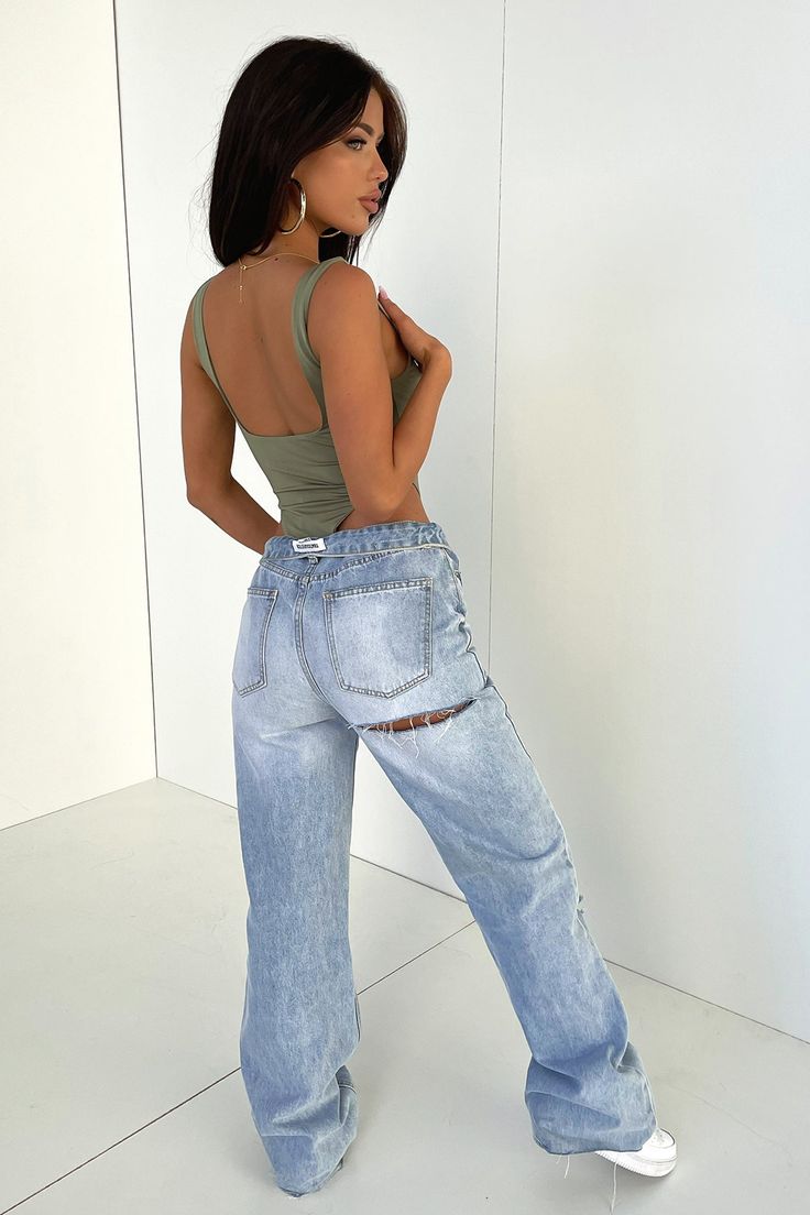 The baddie is in town! Hands down the best pair of denim jeans you'll ever own! She's got lots to offer with a semi-wide leg fit, raw bottom edges, rips at the knee, a cheeky but rip across the back, 2 functioning front + back pockets, a light blue denim wash look and a silver button + zip closure. Style her chic with a white crop + white sneaks and layer it up with a flannel + some chunky silver jewellery and a pair of sunnies. PS: These jeans do not have a-lot of stretch, if you are in between Chunky Silver Jewellery, Silver Button, Usa Outfit, Light Blue Denim, White Crop, Modern Fashion, Silver Jewellery, Denim Wash, Bell Bottom Jeans