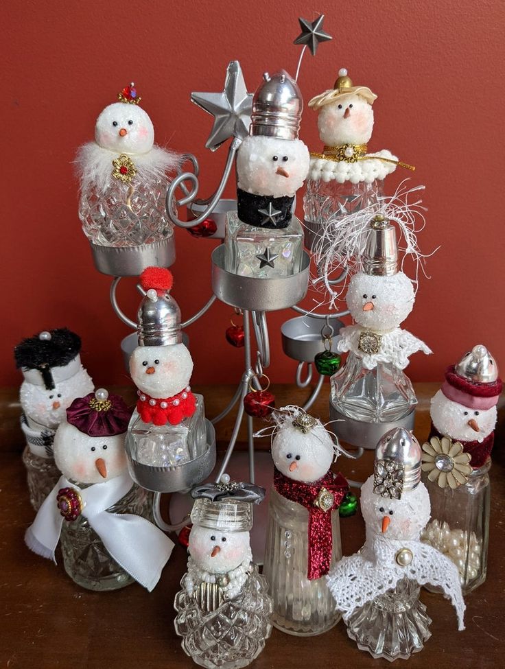 a group of snowmen sitting next to each other on top of a wooden table