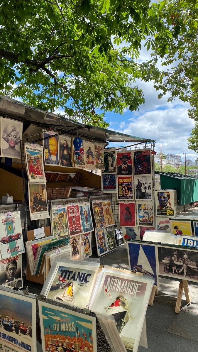 there are many posters on display under the tree