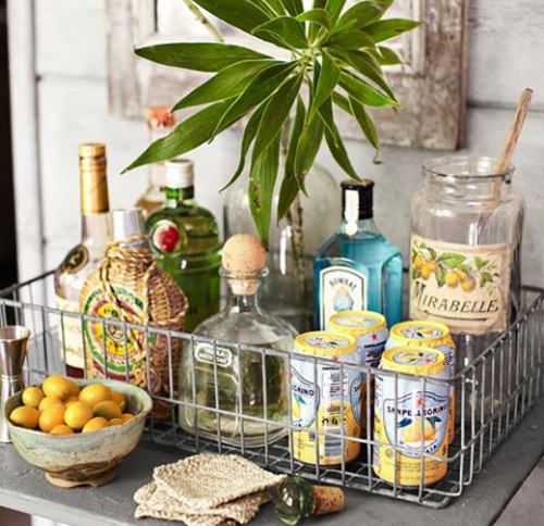 a table topped with bottles and baskets filled with drinks