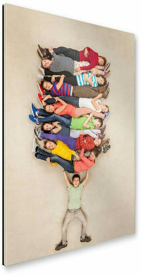 a large group of people standing in front of a wall