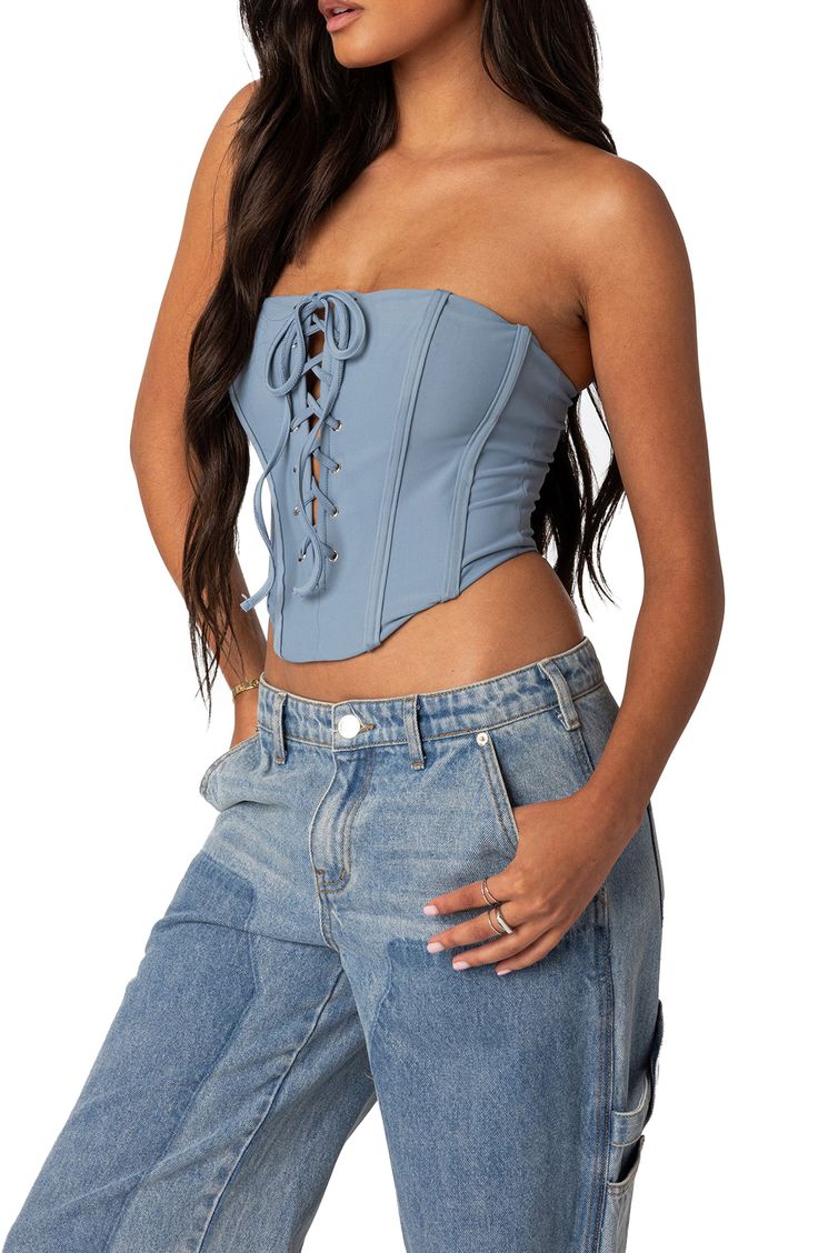 The sultry allure of a corset meets the stretchy softness of a tube top in this lace-up number cut in a strapless silhouette perfect for your next night out. Strapless 95% polyester, 5% spandex Machine wash, dry flat Imported Bandeau Corset Belt With Corset Back For Night Out, Fitted Bandeau Corset With Bandage Details, Bandeau Corset Belt For Night Out, Fitted Bandage Bandeau Corset, Fitted Bandeau Bandage Corset, Spring Tube Top With Corset Back And Sweetheart Neckline, Blue Fitted Bandeau Tube Top, Fitted Blue Bandeau Tube Top, Strapless Corset With Lace-up Back For Night Out