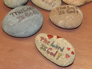 some rocks with writing on them sitting on top of a wooden table next to each other