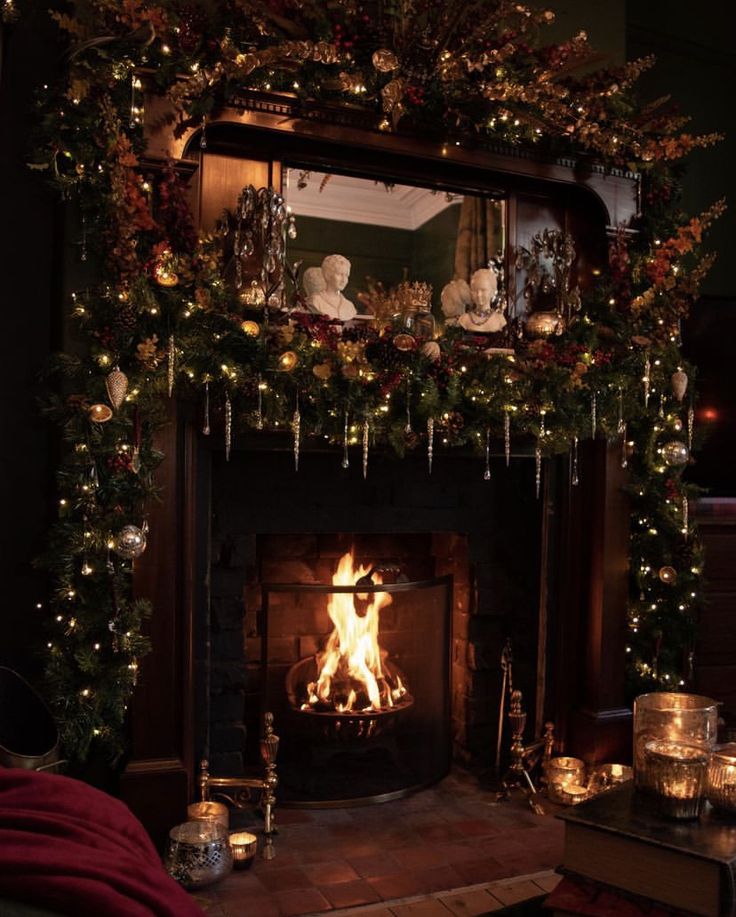 a fireplace decorated for christmas with candles and garland