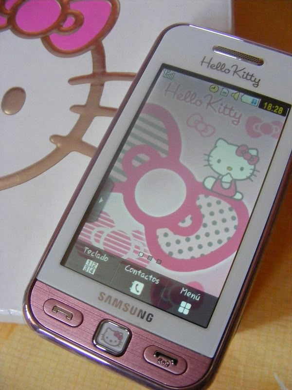 a hello kitty cell phone sitting on top of a table