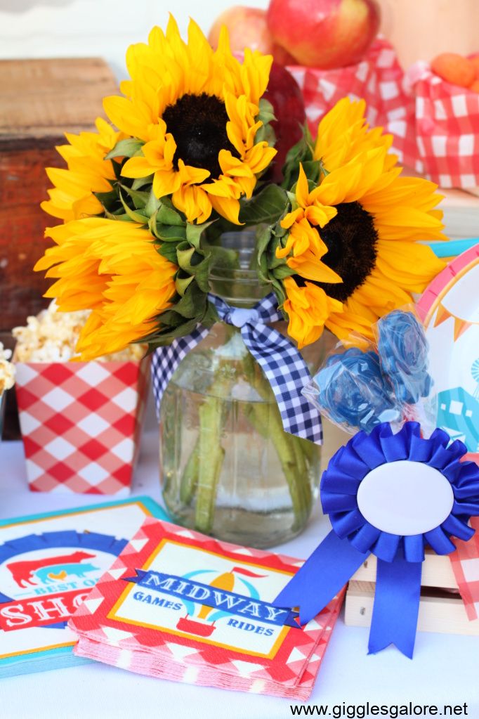 sunflowers are in a vase on a table with other decorations and gifts around it