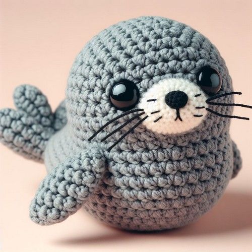 a crocheted stuffed seal animal with big eyes