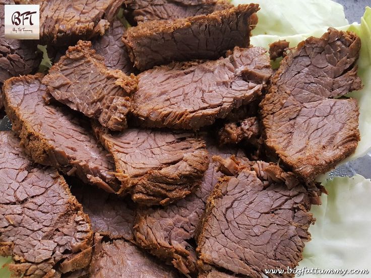 sliced beef sitting on top of lettuce leaves