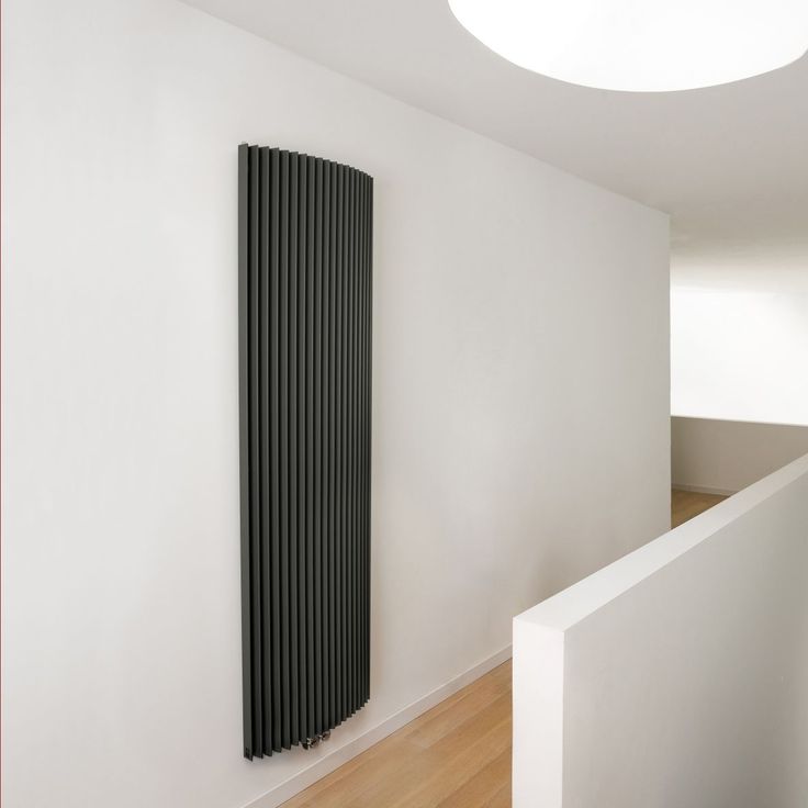 an empty room with a radiator on the wall