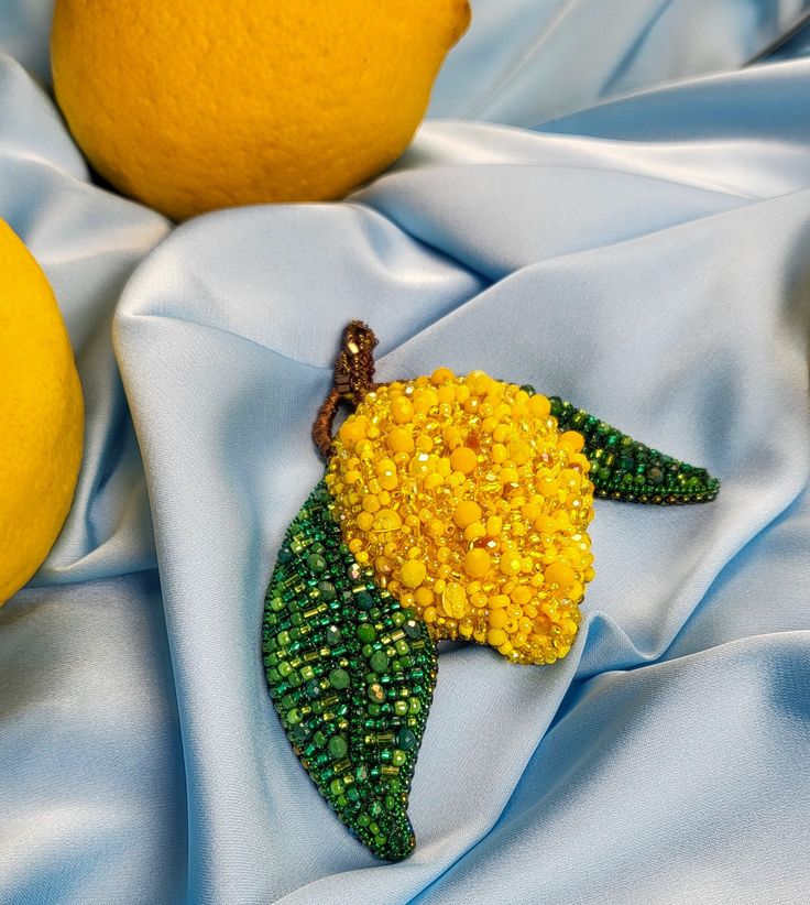 Lemon Tree Brooch A beautiful and unusual Handmade brooch will decorate any of your clothes. This is a beautiful and interesting gift! Good mood will always be with you! Made with love. Be outstanding with Tamusia! Brooch Size: Width: 3.0 inch; Length: 3.1 inch Materials: Beads, Leather,  The brooch will be good packed! Will come to you in a gift box. Thank you that visited my shop, I will be glad you to see again in we wash shop! Follow me on Instagram: https://www.instagram.com/handmade_by_tam Handmade Flower-shaped Pins For Gifts, Handmade Pendant Brooches, Unique Flower Brooches For Jewelry Making, Unique Handmade Pendant Brooch, Unique Handmade Flower Brooches, Unique Handmade Flower Brooch, Unique Flower Shaped Brooches For Gift, Handmade Yellow Brooches As Gifts, Handmade Yellow Brooches For Gift