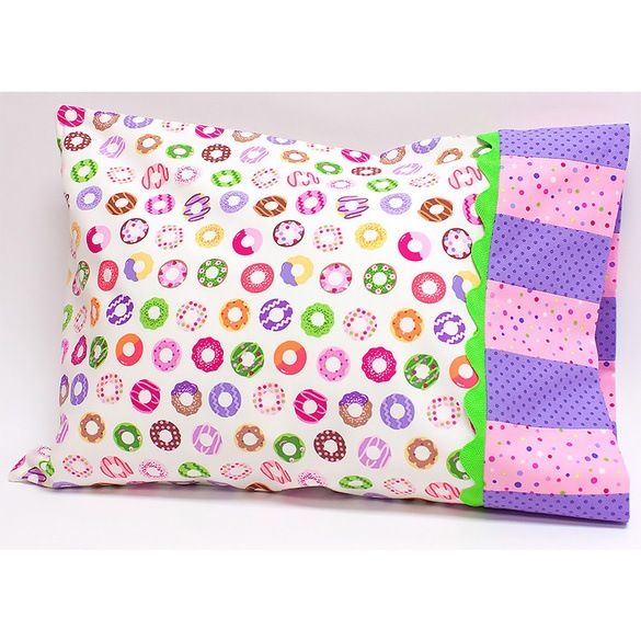 a pillow that has donuts on it and is made out of pink, green, purple