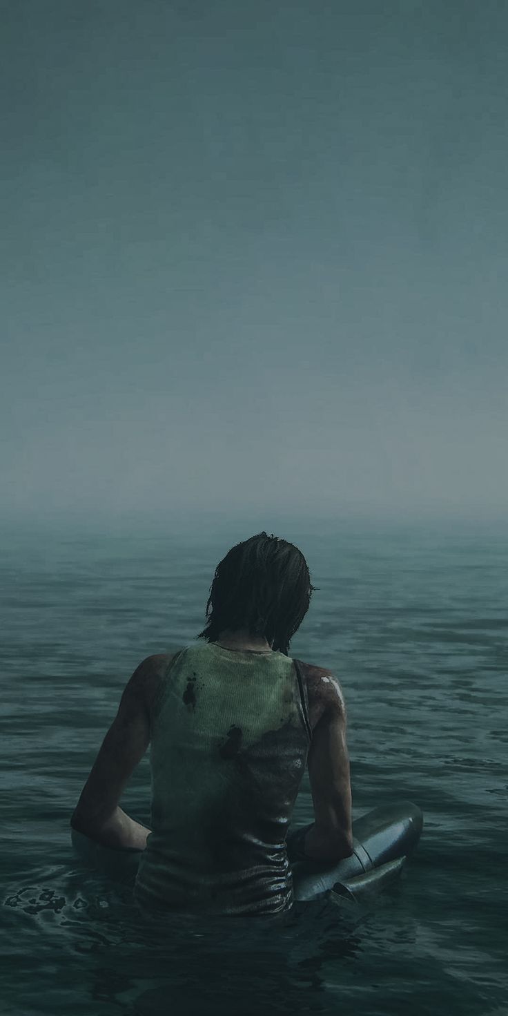 a woman sitting in the water with her surfboard under her arm and looking at the sky