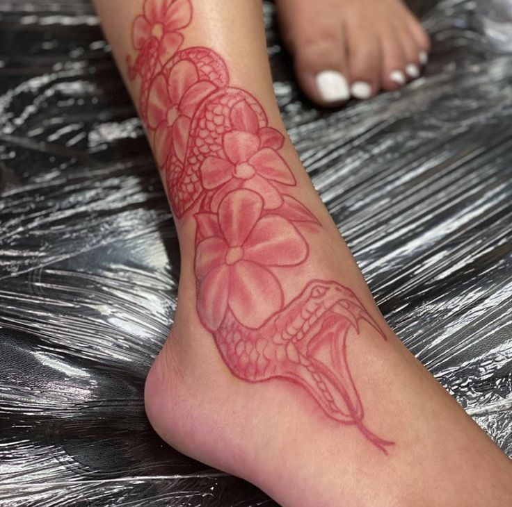 a close up of a person's foot with a tattoo on it