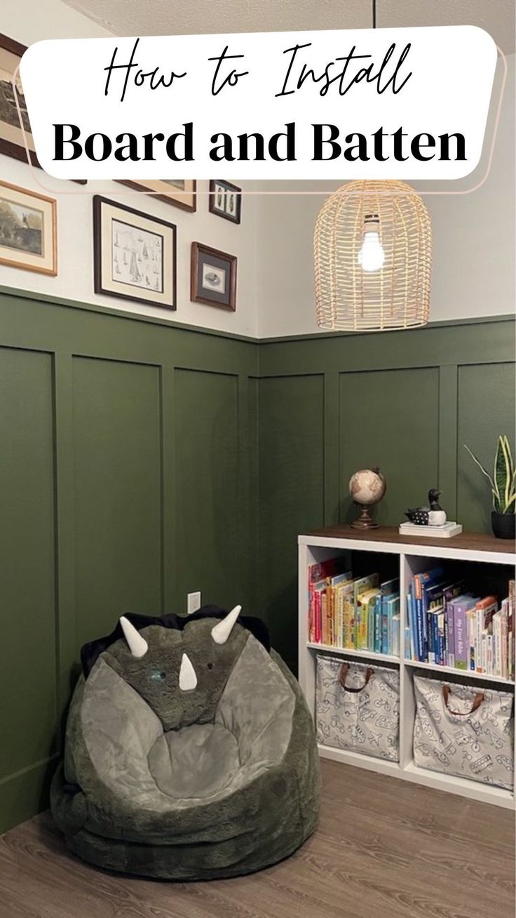 a room with green walls and a large bean bag chair in the corner, next to a bookshelf