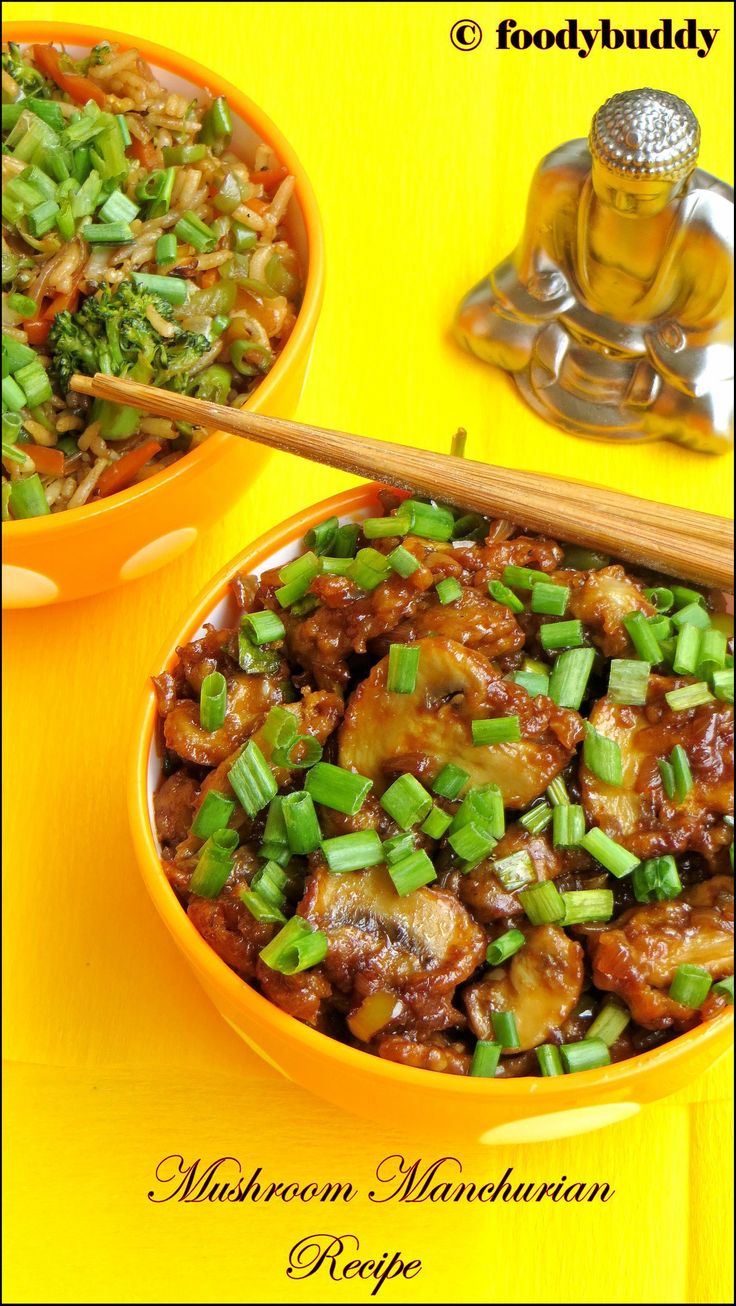 two bowls filled with meat and vegetables next to a wooden spoon on a yellow table