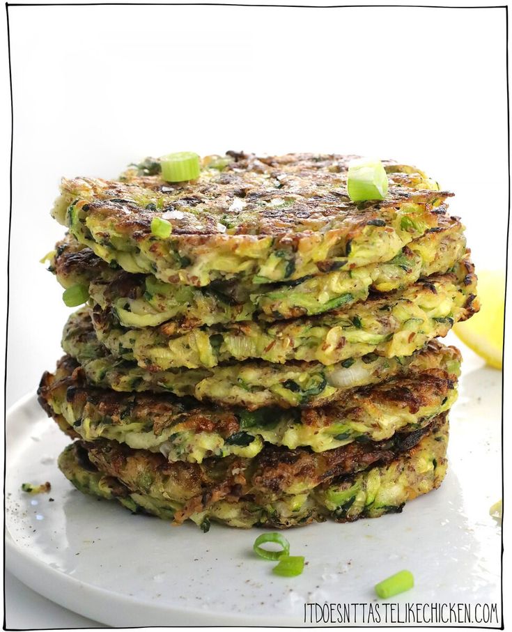 a stack of zucchini fritters on a white plate