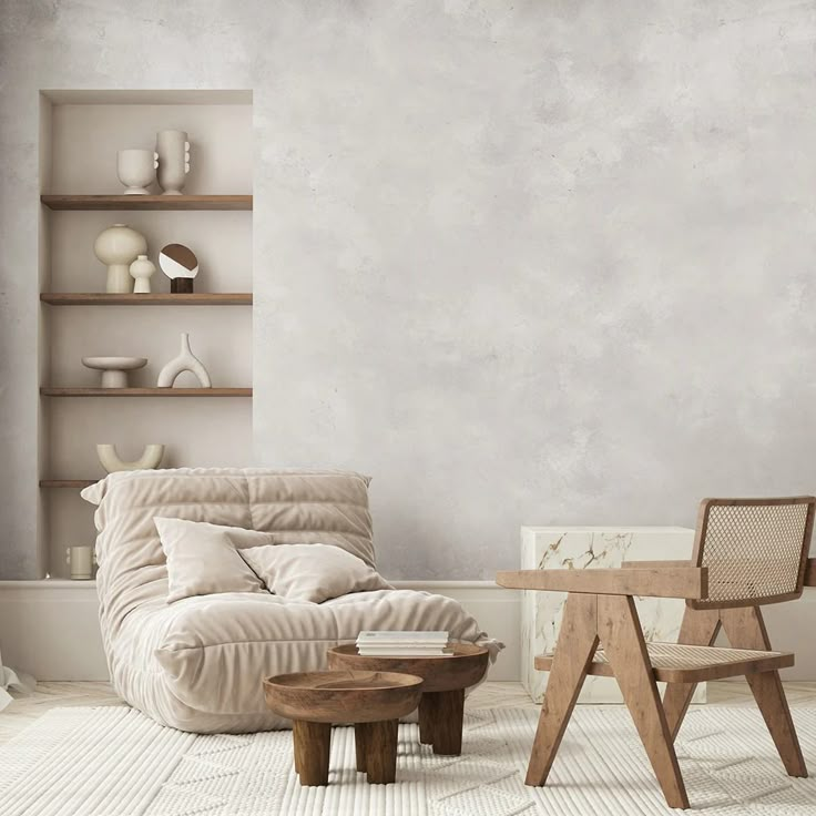 a living room with a chair, table and shelves on the wall next to it